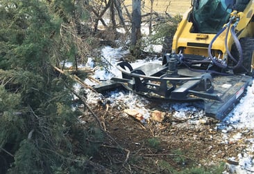 Virnig open front skid steer brush cutter cutting down tree debris